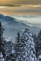 Romanian sunset landscape over Bucegi Mountains in winter season