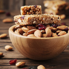 Cereal bar with almond and berry on thw wooden table