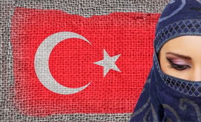 Beautiful muslim girl wirh Turkish flag on background