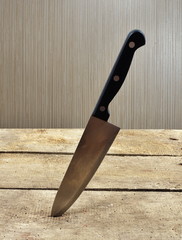 knife stucked in wooden table