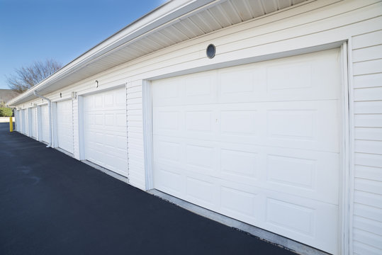 Row Of Garage Doors At Parking Area For Apartment Homes