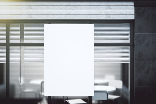 Blank white poster on transparent wall in modern conference offi