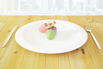 Multicolor pilsl in white roound plate with fork and knife on wo
