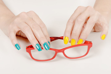 Woman hands with red glasses
