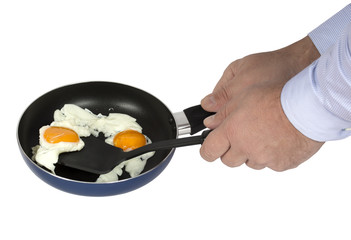 The man cooking omelette in frying pan