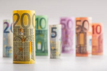 Several hundred euro banknotes stacked by value.Rolls Euro  banknotes.Euro currency money.Announced cancellation of five hundred euro banknotes. Banknotes stacked on each other in different positions