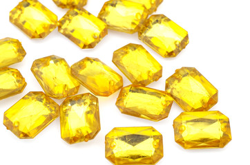 Yellow rhinestone on white background
