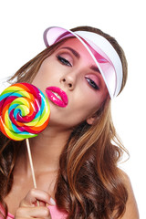 beautiful woman eating big red lollipop in sun hat 