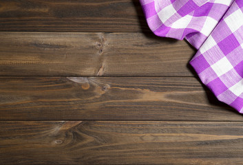 Purple napkin on the old wooden table.