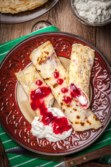 Rolled crepes stuffed with cottage cheese.