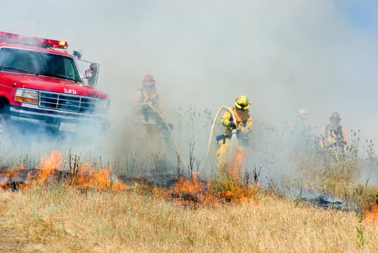 Wildland Firefighter fighting fire with fire truck