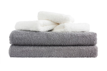 Stack of grey and white bath towels. Isolated over white background 