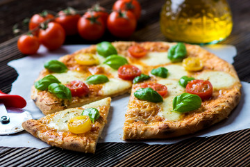 Homemade pizza with mozzarella, cherry tomatoes and Basil