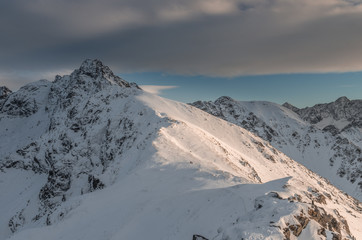 Fototapeta na wymiar Swinica peak in High Tatras at winter, illuminated by afternoon sun