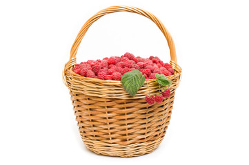 Fototapeta na wymiar Fresh ripe red raspberries in a wicker bowl