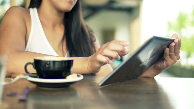  Woman hands working with tablet computer in cafe
