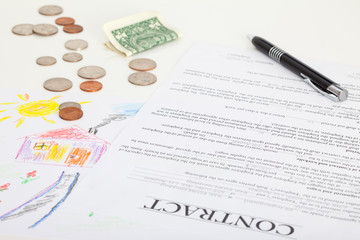 Contract of house sale or mortgage papers with a piggy and money on the document. Suitable for real estate concept. 