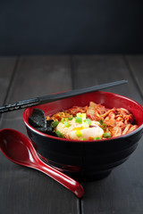 Korean Ramen with Kimchi and seaweed on brown wooden table