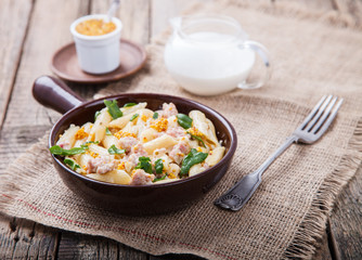 Pasta with meat , herbs and cream with a sauce of grain mustard.