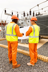 industrial engineers discussing blueprint