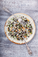 Salad of white and wild rice with pine nuts and herbs.selective focus.