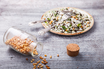 Salad of white and wild rice with pine nuts and herbs.selective focus.
