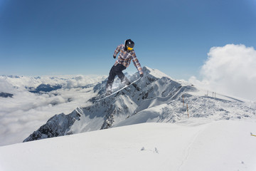 Flying snowboarder on mountains. Extreme sport.