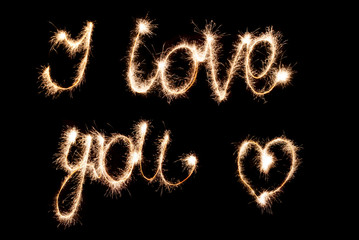 I love you . Inscription sparklers on a dark background.