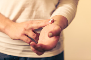 Woman checking pulse on wrist closeup