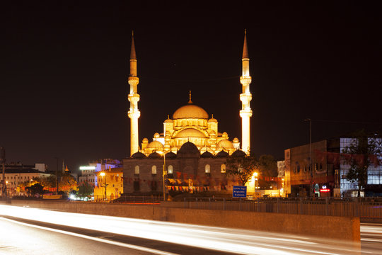 The New Mosque in Istanbul, Turkey at night with city traffic 