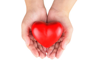 Hands holding a red heart as symbol for love and care