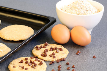 preparation pastry: chocolate chip cookies on grey background with copy space
