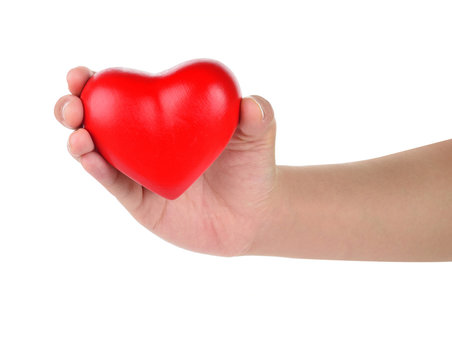 Hands holding a red heart as symbol for love and care