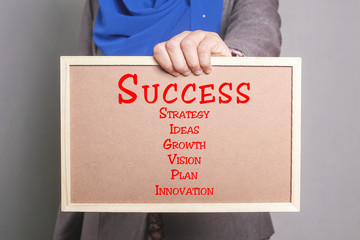 Fototapeta na wymiar Businesswoman holding a softboard written Success Concept