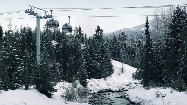 Pan Up From River To Ski Lift