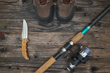 fishing tackles and fishing gear on wooden background