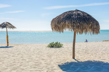 Beach Umbrella made of palm leafs on exotic beach