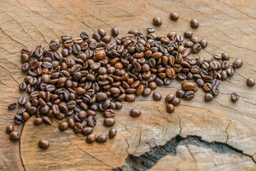 pile of Coffee beans on wooden surface background
