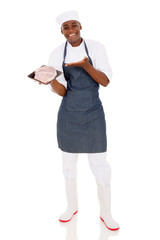 young african butcher presenting quality meat