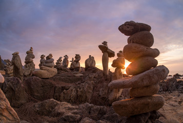 Stones pyramid on sand symbolizing zen, harmony, balance. Ocean