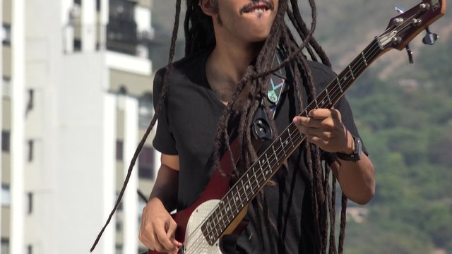 African Reggea Guitarist With Dreadlocks Jumping