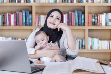 Mother and baby dreaming in library