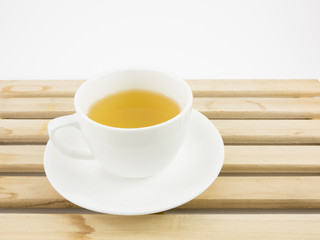 The cup of Japanese green tea on wooden tray.