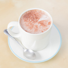 Hot chocolate in a white cup on table