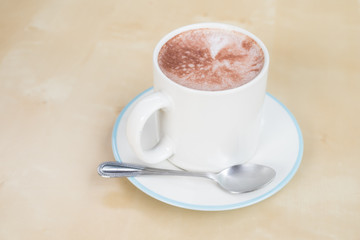 Hot chocolate in a white cup on table