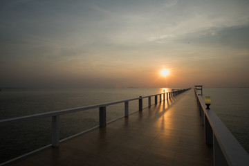 Obraz premium Sunset on beach and bridge / Beautiful sunset on Thailand beach on bridge