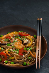 Buckwheat noodles with seafood , closeup vertical