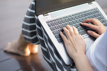 Young woman using laptop on steps outdoors