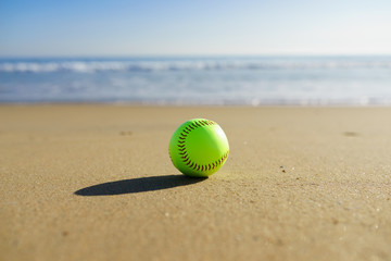 Softball at a California beach with white wave in pacific ocean