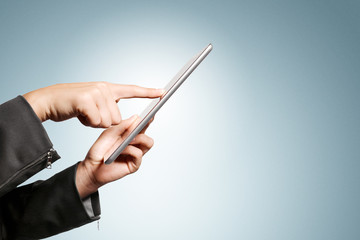 Isolated woman hand holding the phone tablet touch computer gadget.